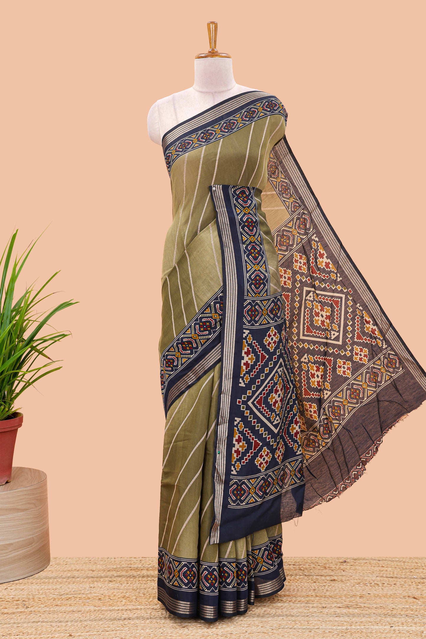 Green chanderi cotton saree featuring diagonal stripes and ikkat print pallu