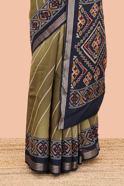 Green chanderi cotton saree featuring diagonal stripes and ikkat print pallu