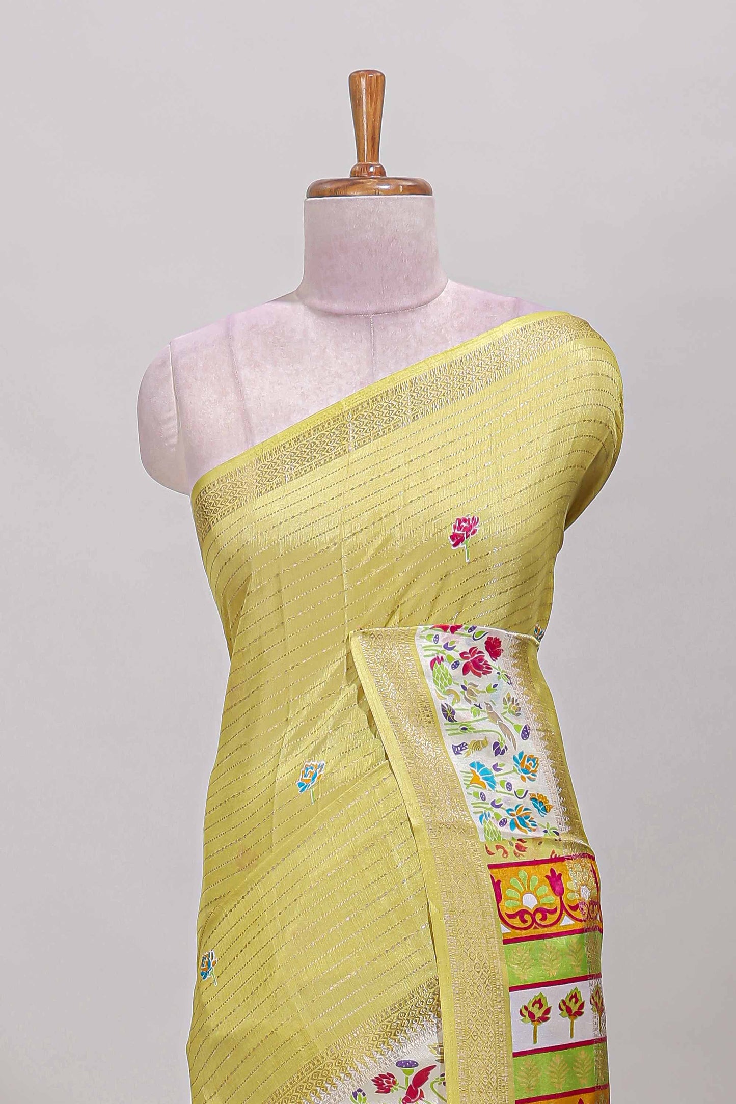 Yellow dola silk saree with striped floral motifs and bird & floral bottom design with self zari border and matching blouse