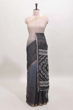 Cream and black dual shade checked checked linen cotton saree with self zari border printed blouse