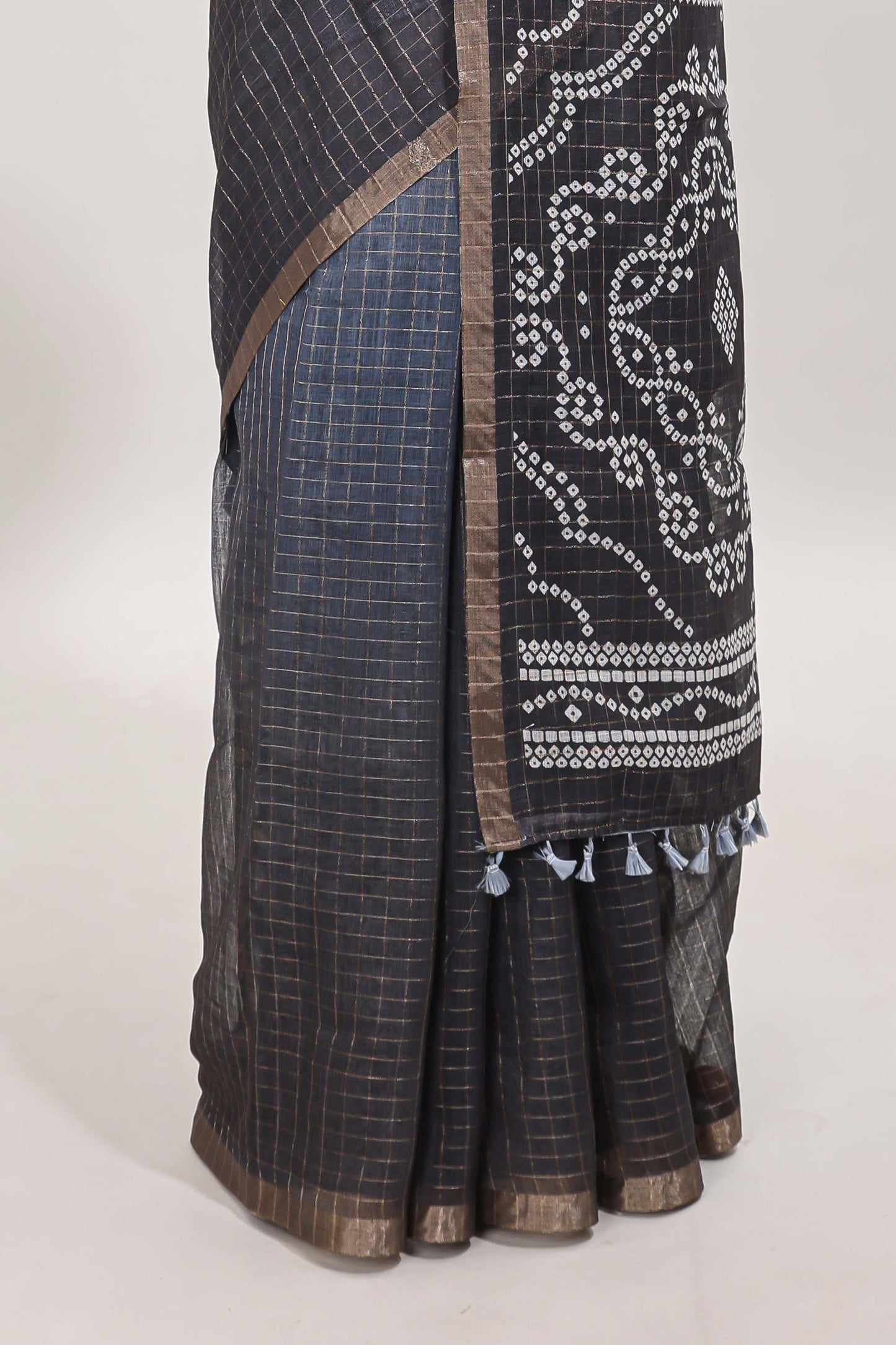 Cream and black dual shade checked checked linen cotton saree with self zari border printed blouse