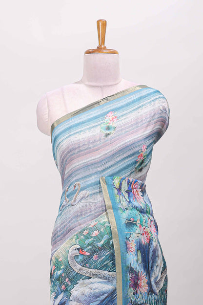 Blue linen cotton saree with swan & lotus pond print, self zari border and matching printed pallu