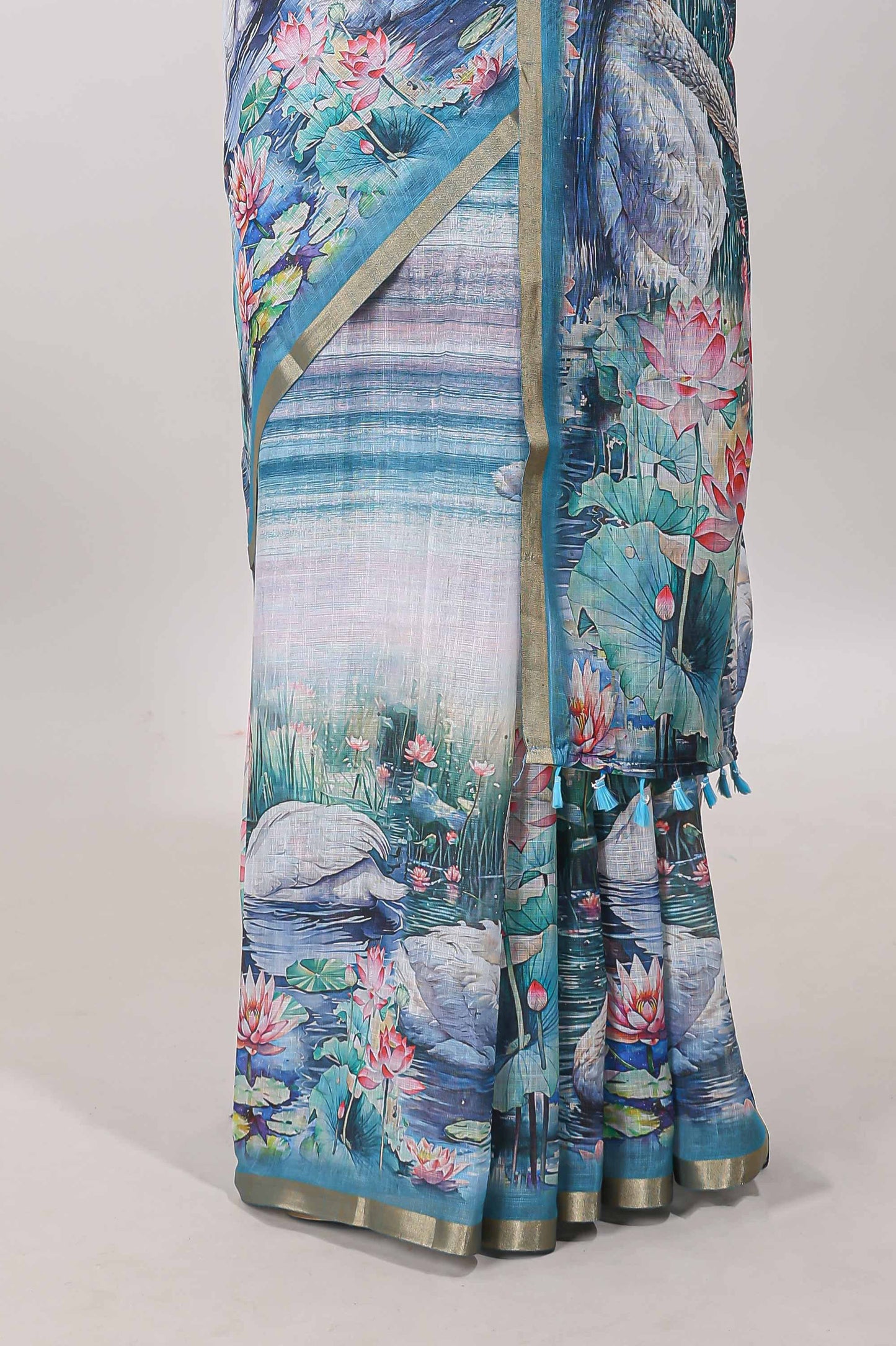 Blue linen cotton saree with swan & lotus pond print, self zari border and matching printed pallu