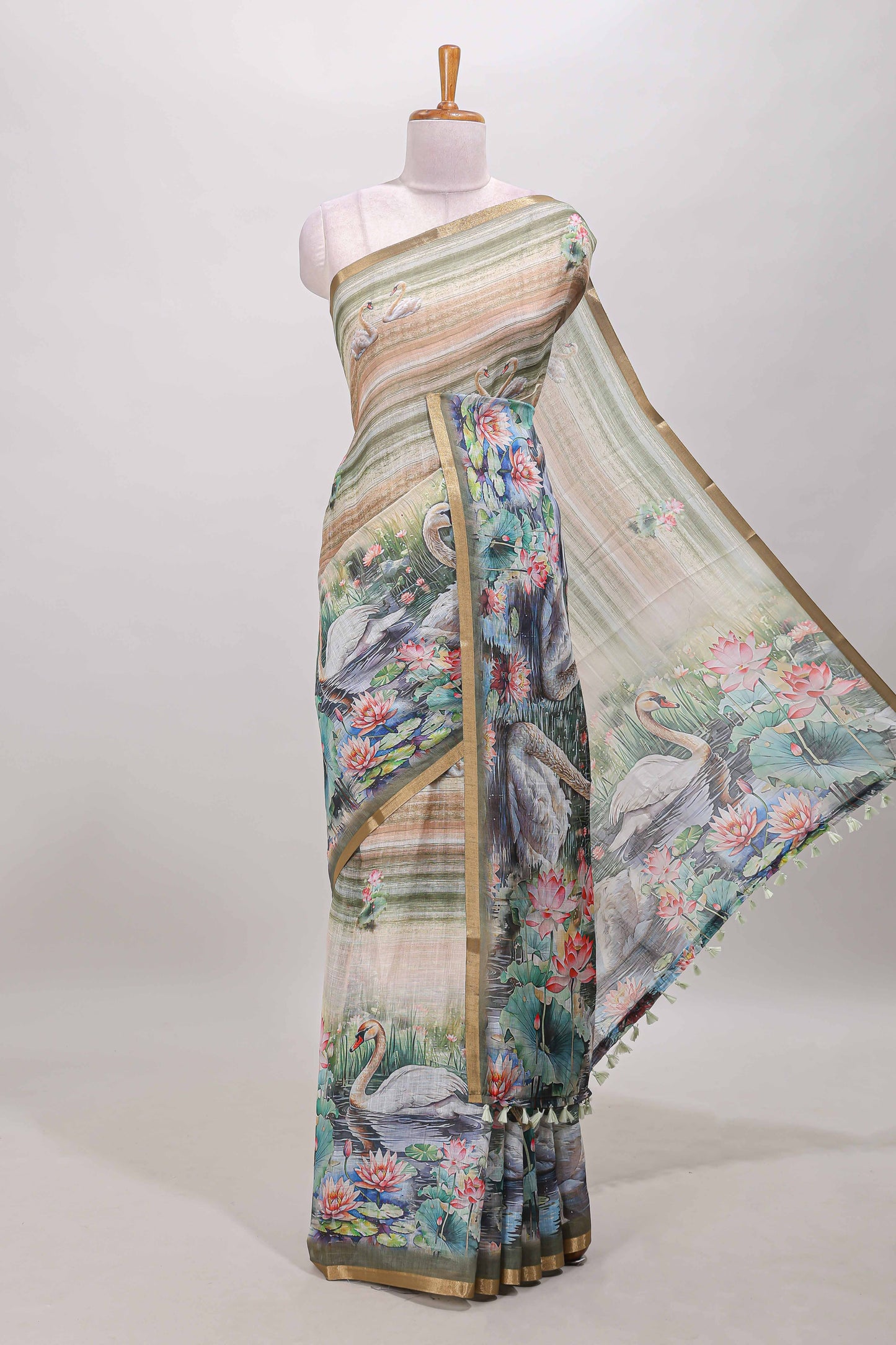 Olive green linen cotton saree with swan & lotus pond print, self zari border and matching printed pallu