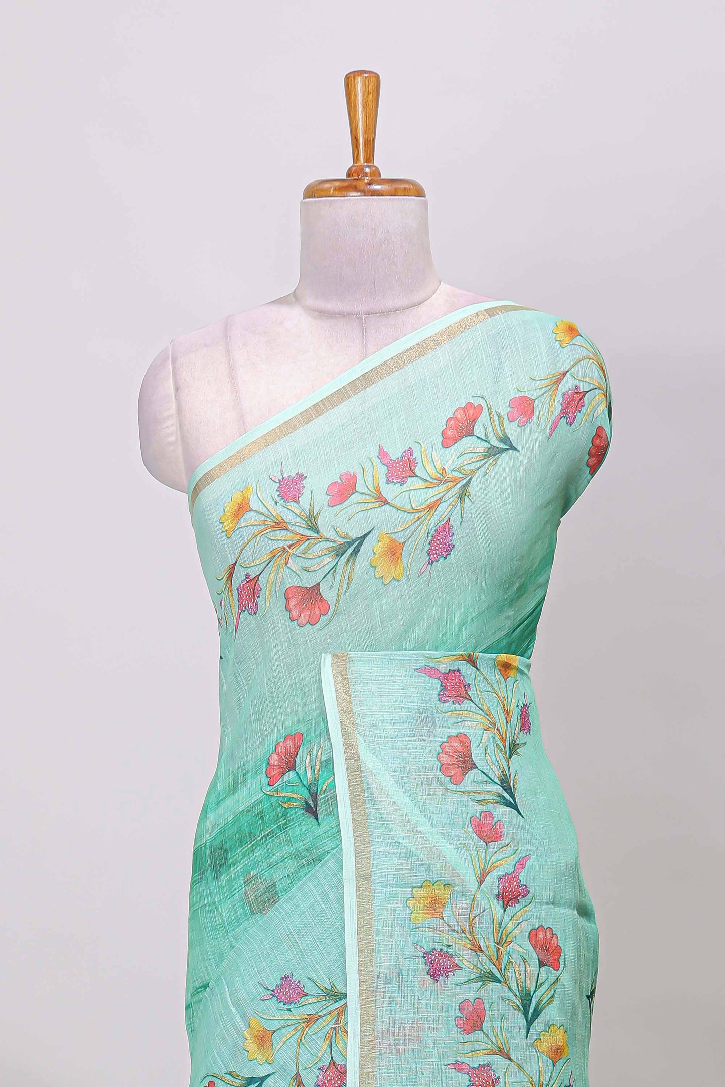 Green linen cotton saree with floral vines print, zari border and printed blouse