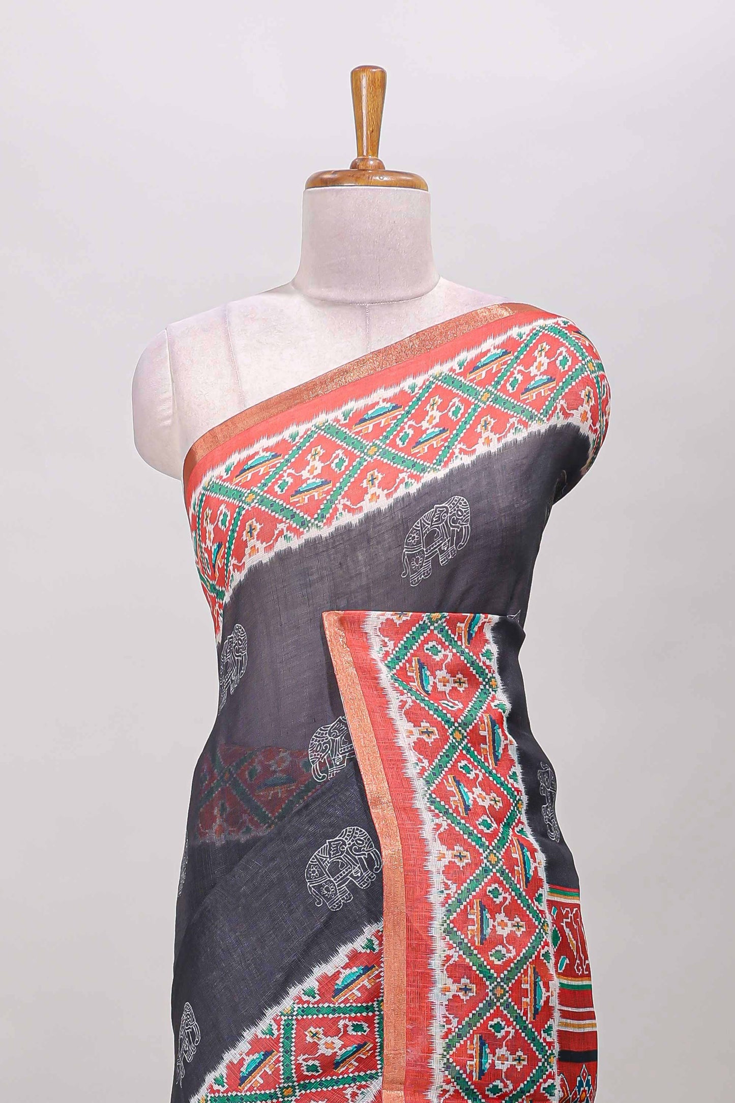 Black elephant motifs linen cotton saree with contrast ikkat style border and printed blouse