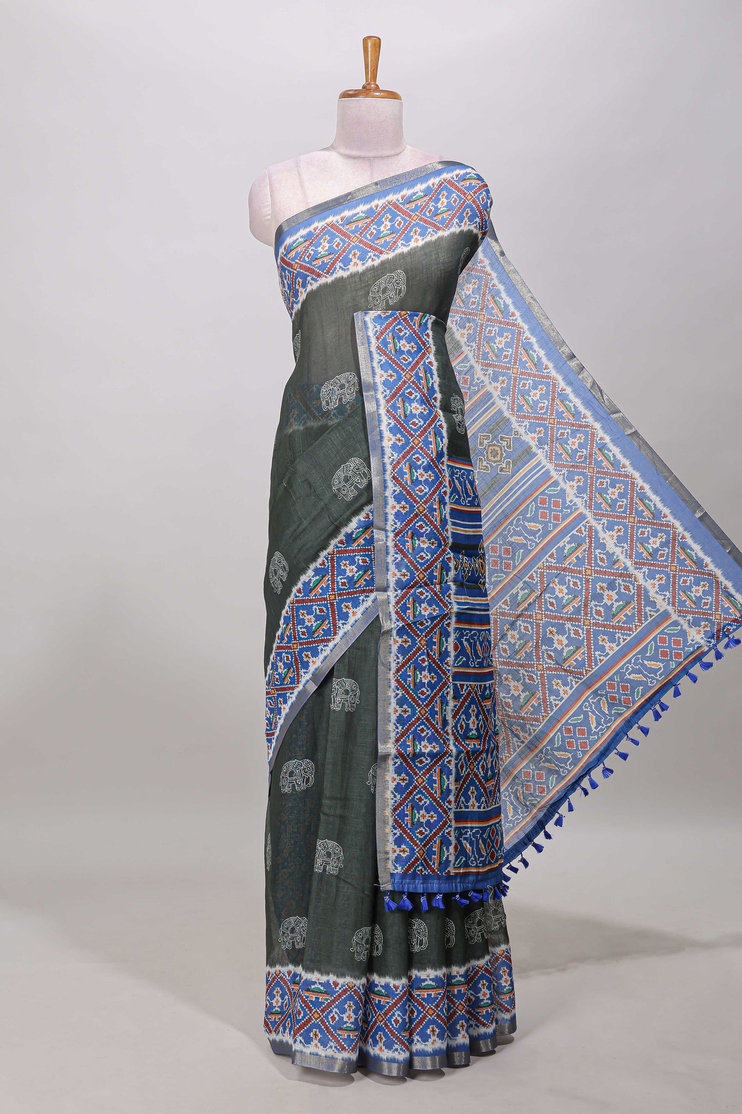 Forest green elephant motifs linen cotton saree with contrast ikkat style border and printed blouse