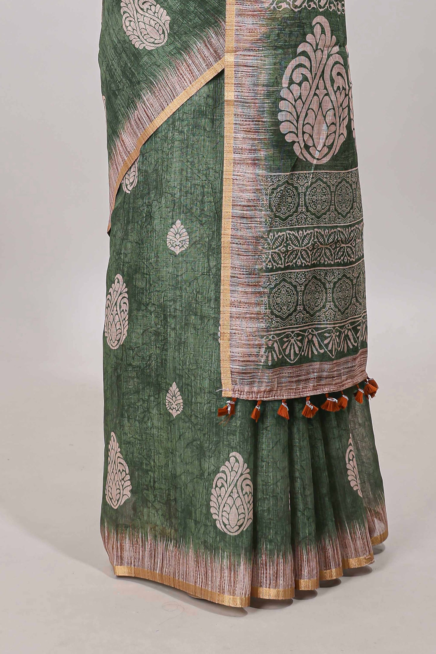 Green paisley motifs linen cotton saree with self zari border and matching blouse