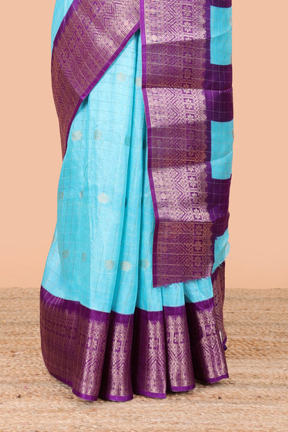 Blue viscose dola silk saree with all over checked butta design, contrast zari border and pallu
