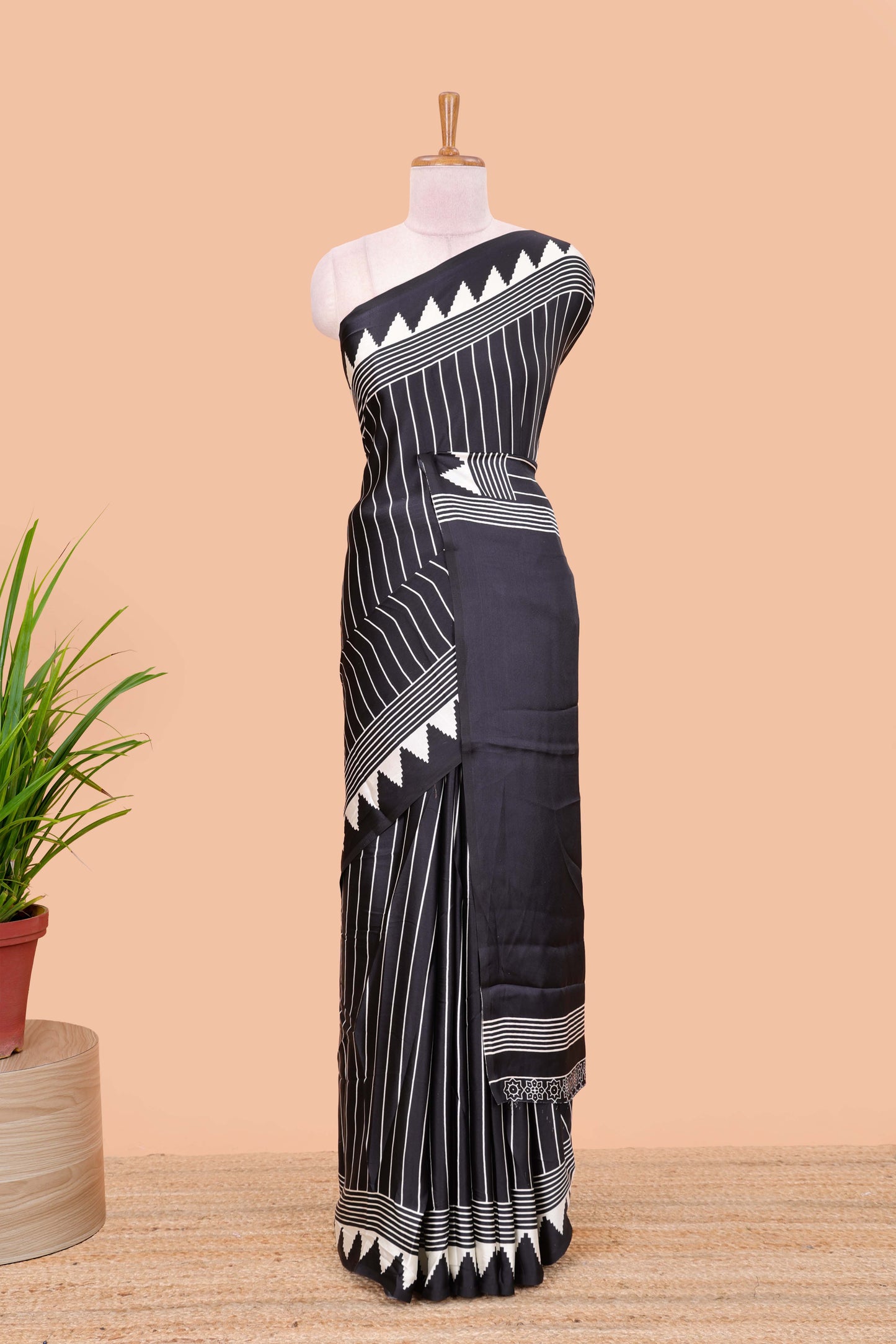 Black satin ajrakh modal printed saree with striped body and geometric print border and pallu