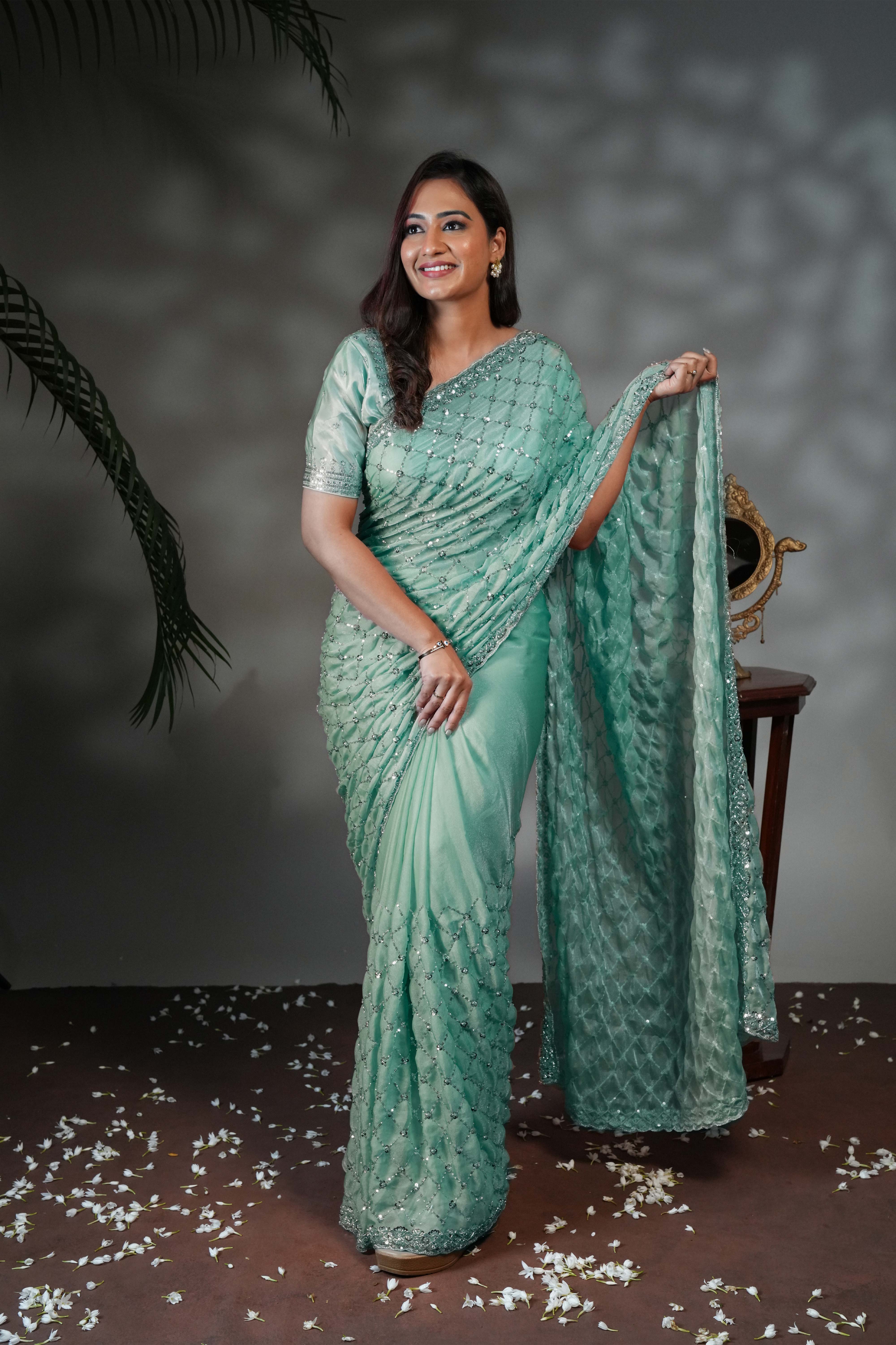 Turquoise green geometric pattern stone work all over body designer saree with scallop design border matching blouse
