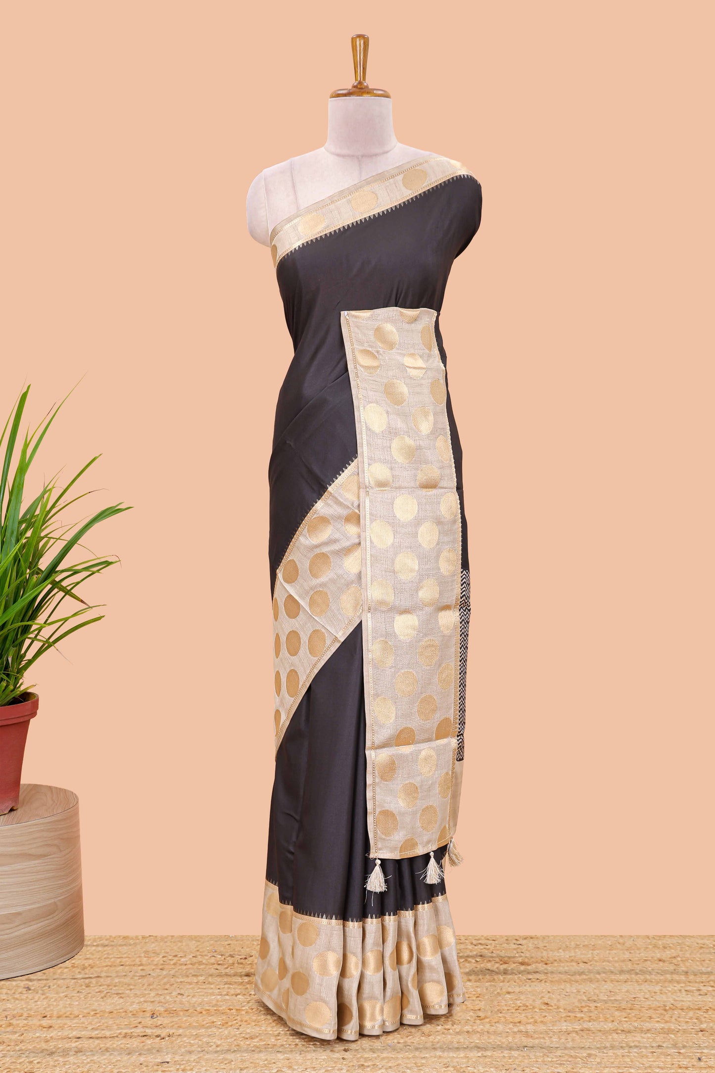 Black art tussar saree with plain body, cream coin motif zari border and zig-zag printed pallu