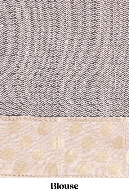 Black art tussar saree with plain body, cream coin motif zari border and zig-zag printed pallu