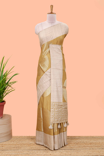 Mustard art tussar saree with large circular zari buttas and contrast cream floral pallu