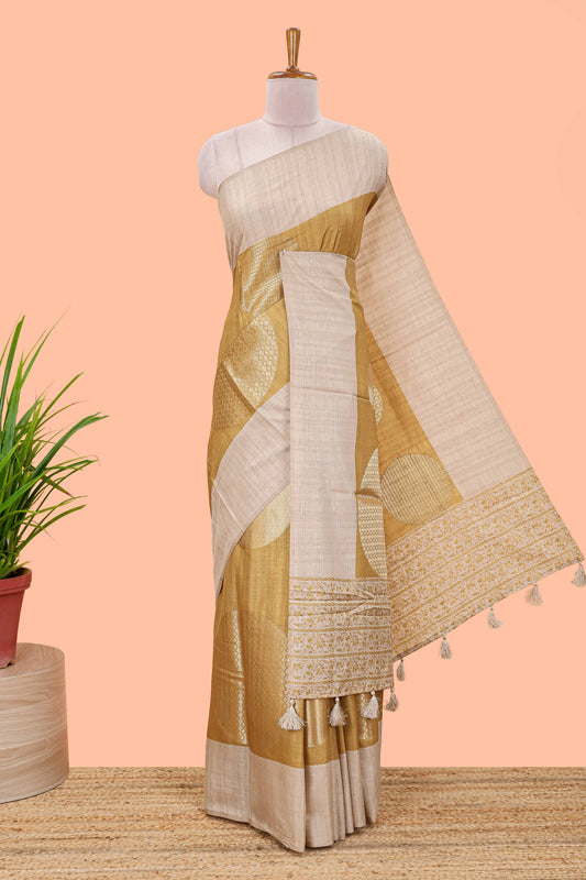 Mustard art tussar saree with large circular zari buttas and contrast cream floral pallu
