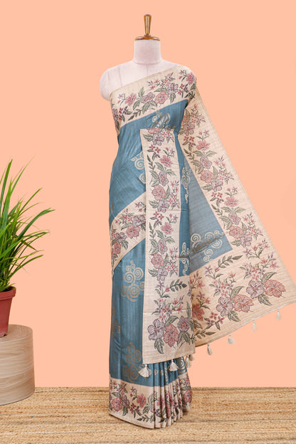 Blue art tussar silk saree with rich floral zari butta weave and cream floral border and pallu