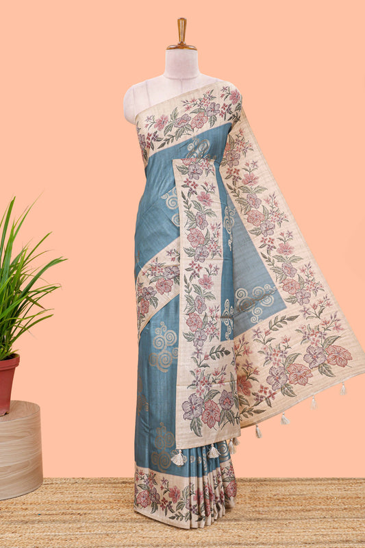 Blue art tussar silk saree with rich floral zari butta weave and cream floral border and pallu