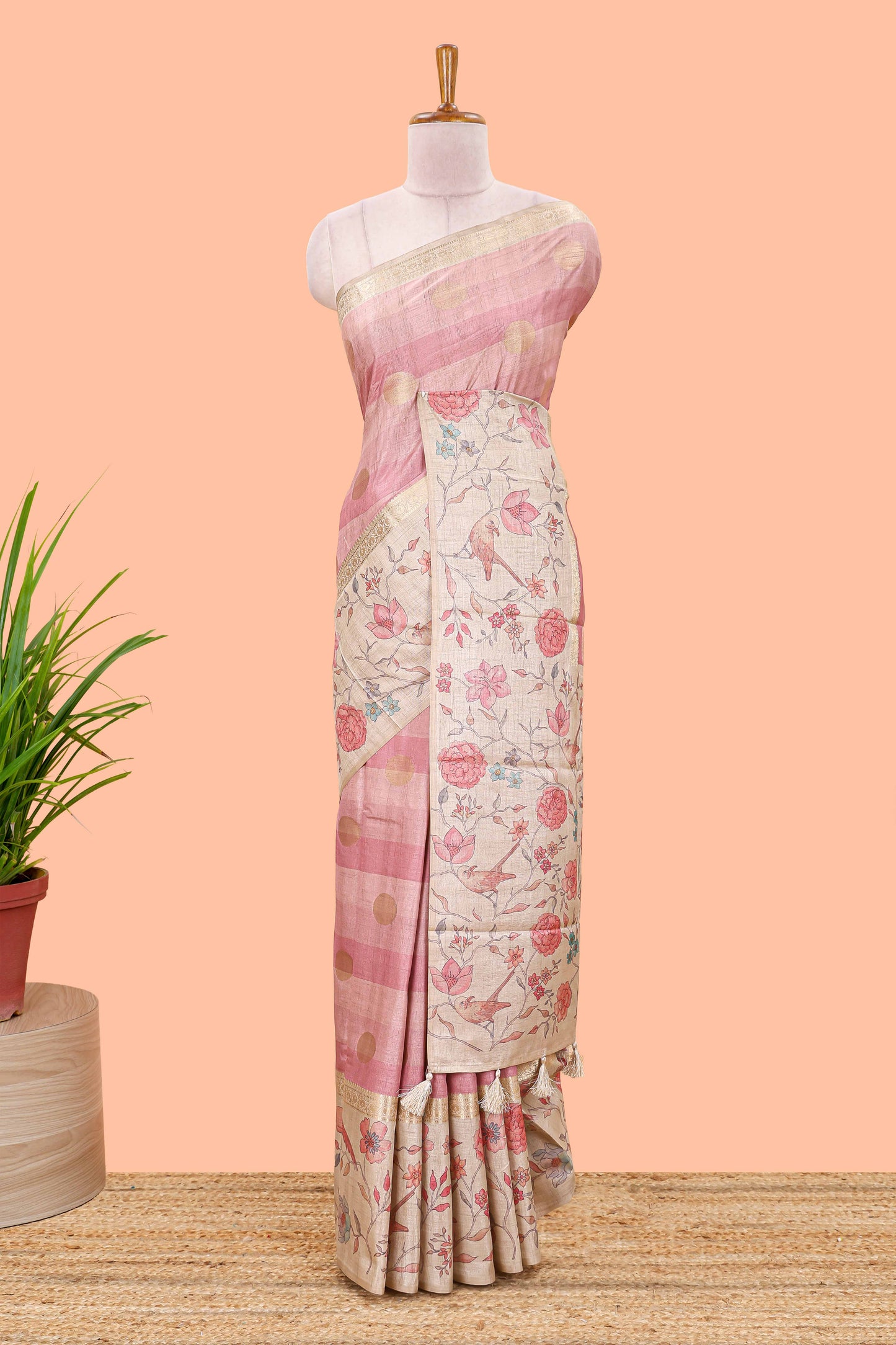 Pink art tussar saree featuring round zari butta body with floral and bird motif printed border and pallu