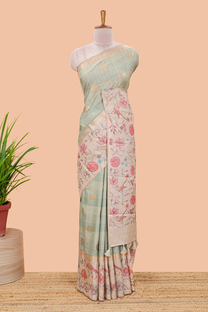 Pista green art tussar saree featuring round zari butta body with floral and bird motif printed border and pallu