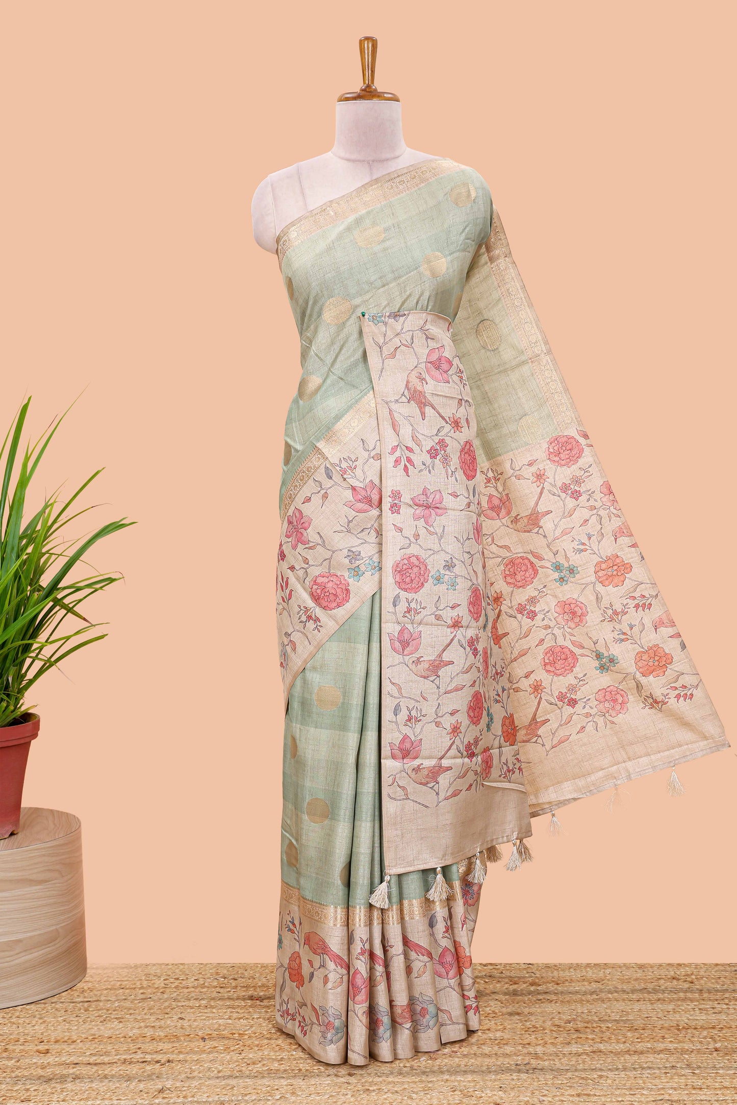 Pista green art tussar saree featuring round zari butta body with floral and bird motif printed border and pallu