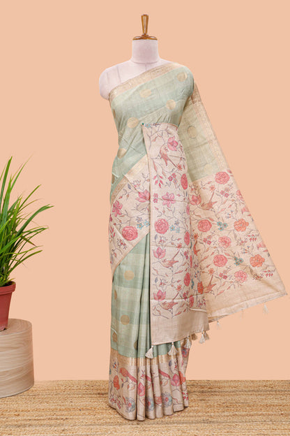Pista green art tussar saree featuring round zari butta body with floral and bird motif printed border and pallu