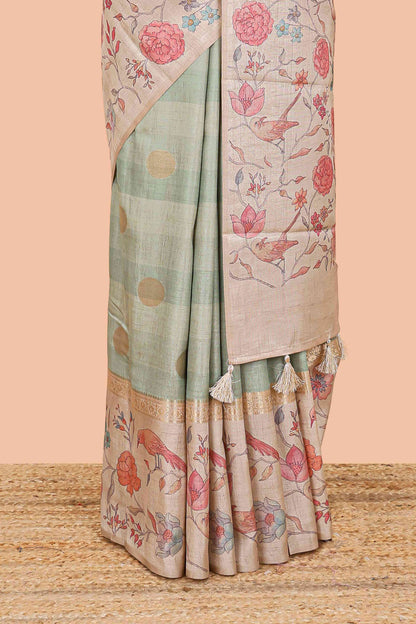 Pista green art tussar saree featuring round zari butta body with floral and bird motif printed border and pallu