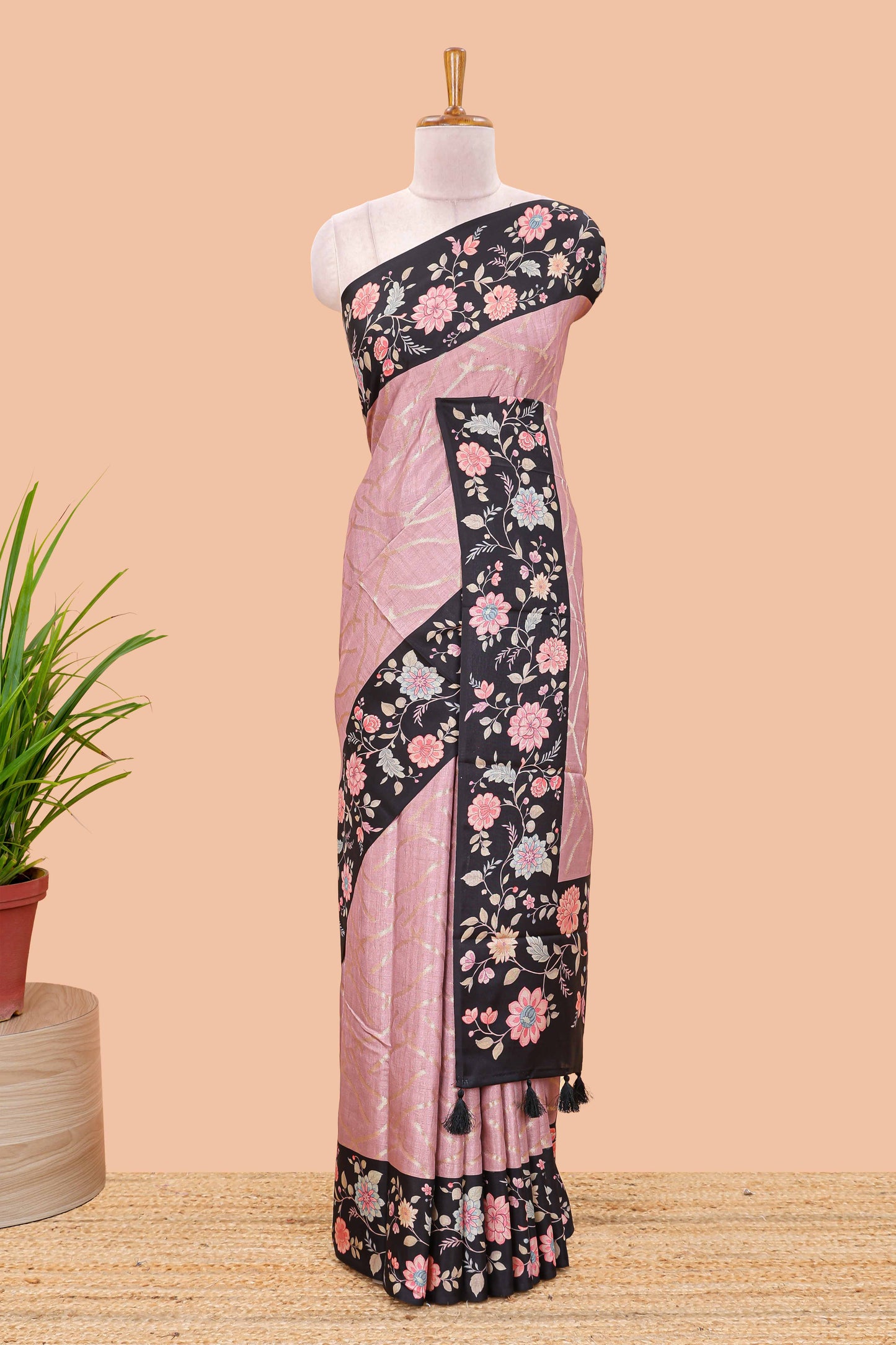 Peach art tussar saree with wave zari weaving body and black floral print border and pallu