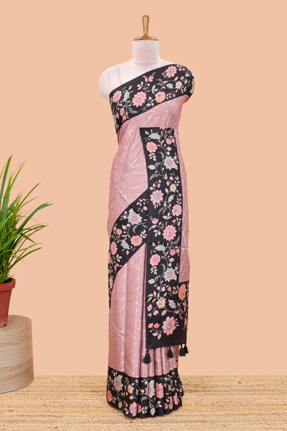 Peach art tussar saree with wave zari weaving body and black floral print border and pallu