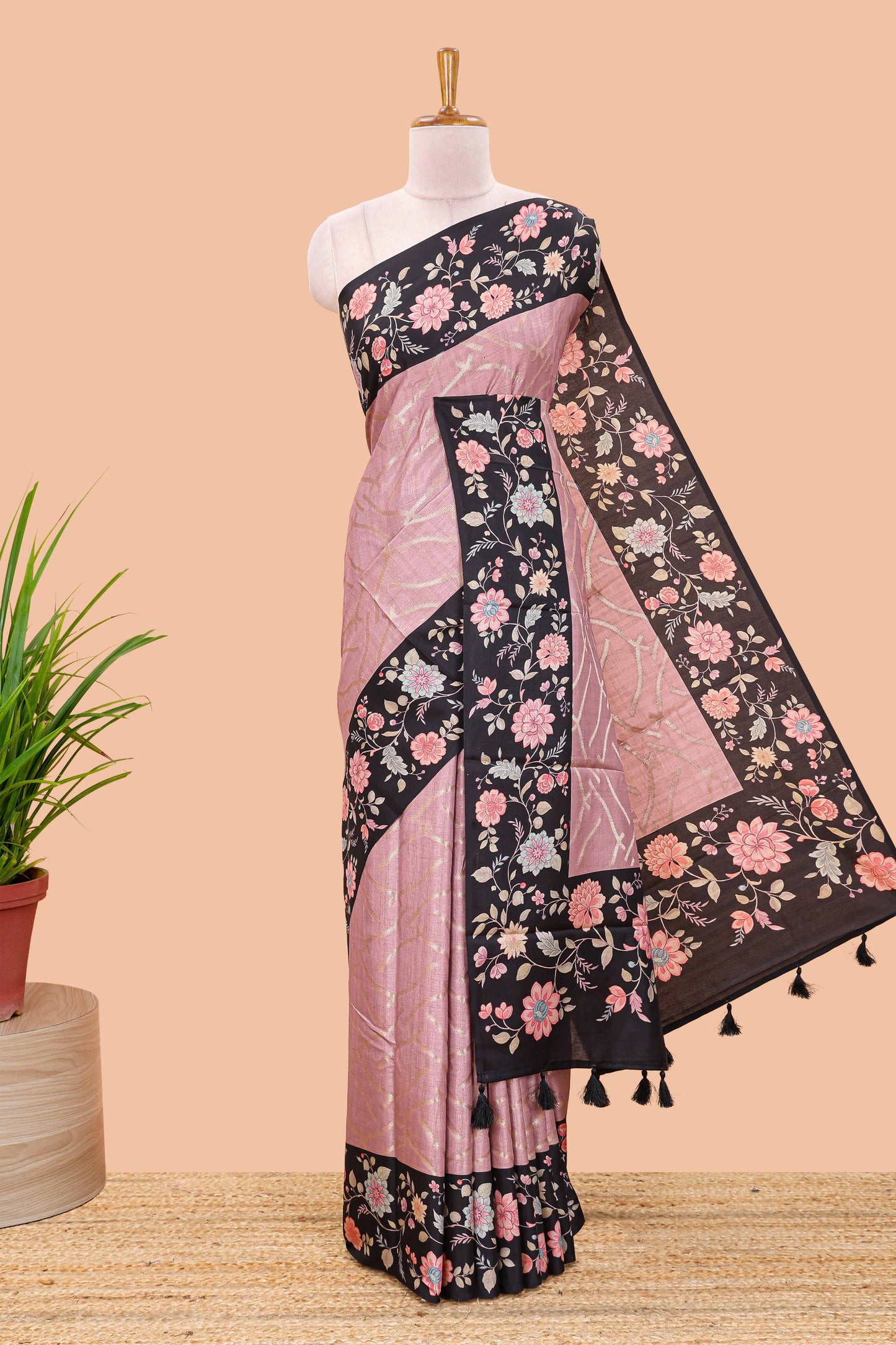 Peach art tussar saree with wave zari weaving body and black floral print border and pallu