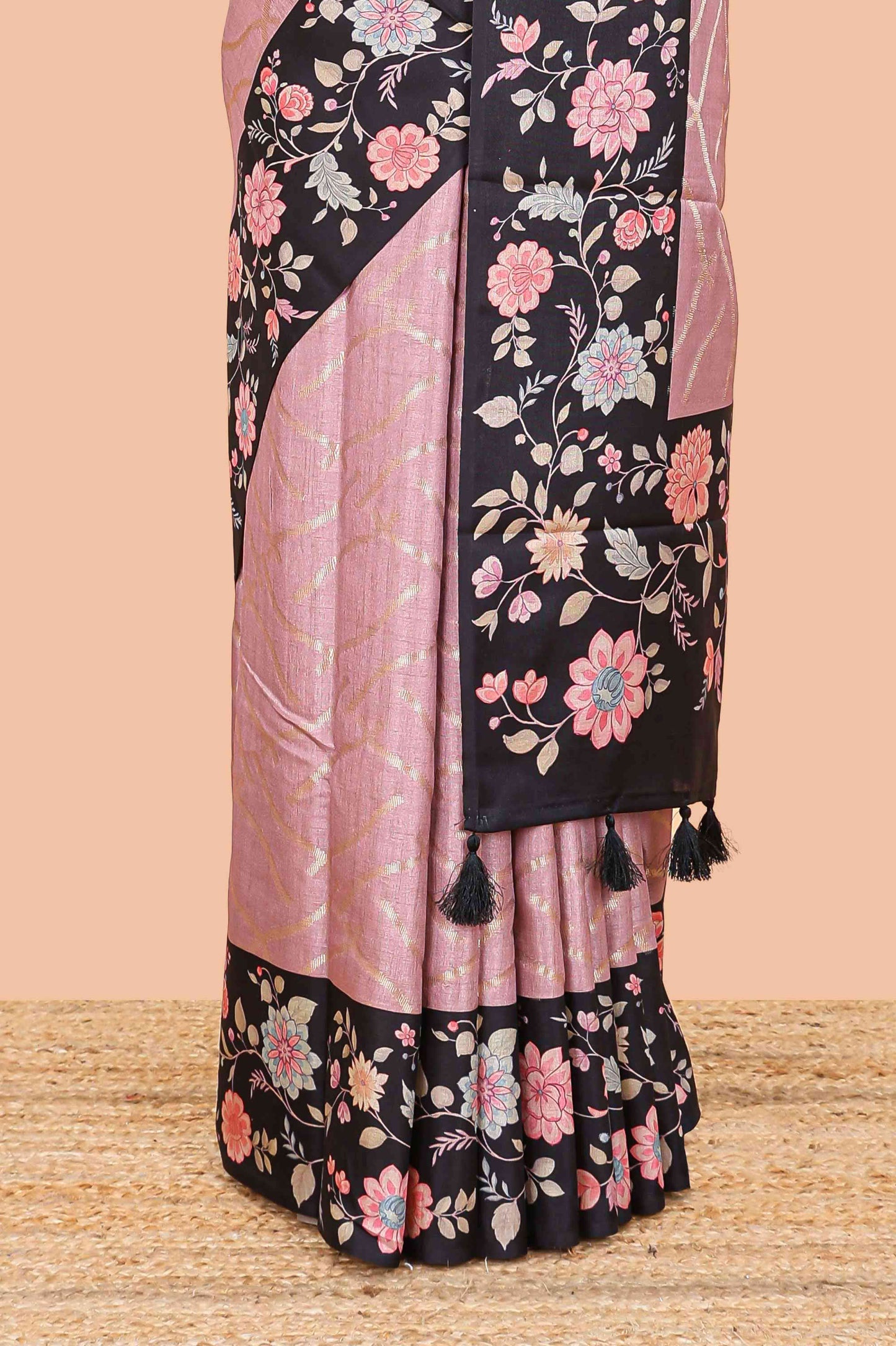 Peach art tussar saree with wave zari weaving body and black floral print border and pallu