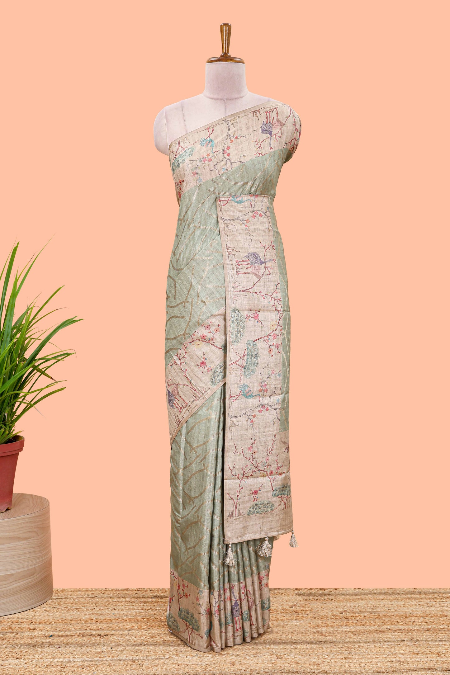 Green art tussar saree with wave zari weaving body and cream nature print border & pallu