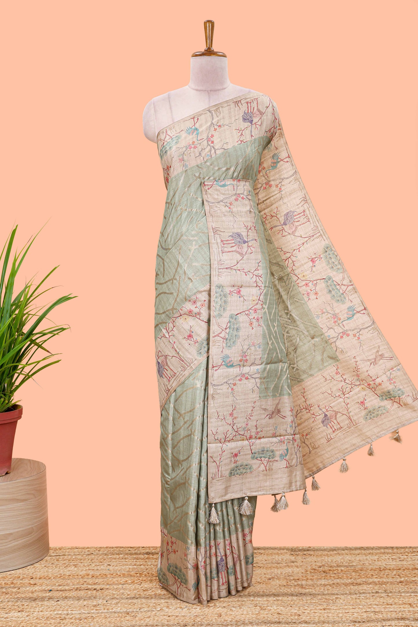 Green art tussar saree with wave zari weaving body and cream nature print border & pallu