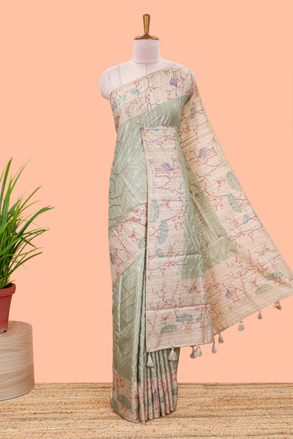 Green art tussar saree with wave zari weaving body and cream nature print border & pallu