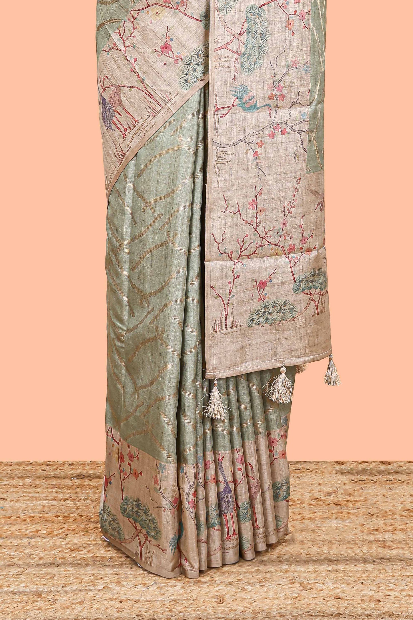 Green art tussar saree with wave zari weaving body and cream nature print border & pallu