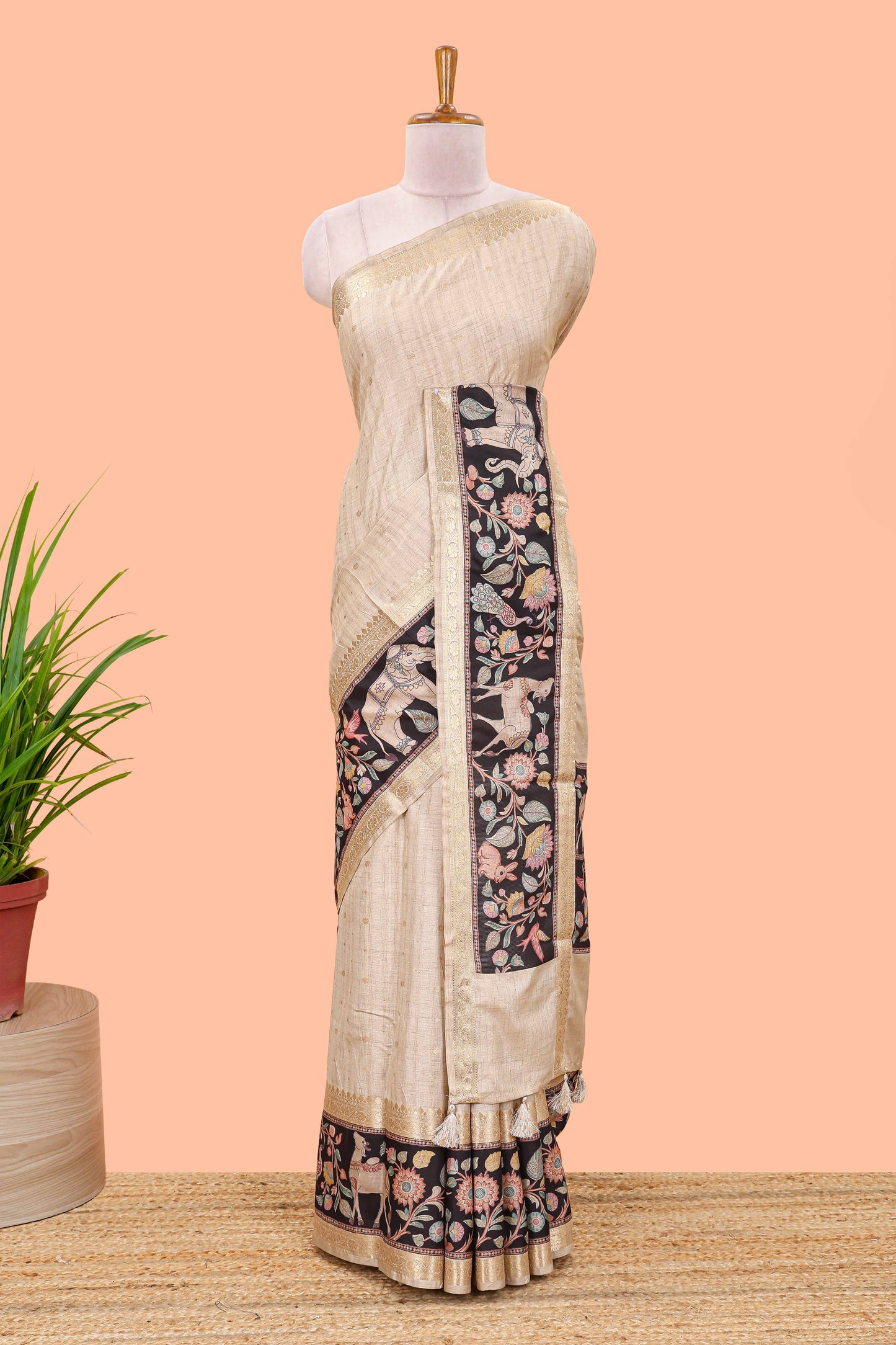 Beige art tussar silk saree featuring zari butta and Black retta-patta border with kalamkari animal designs