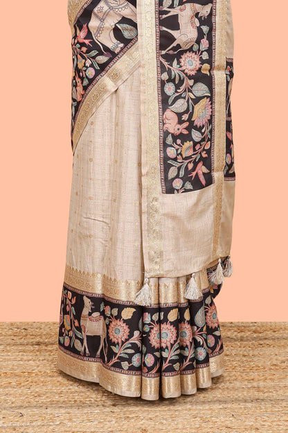 Beige art tussar silk saree featuring zari butta and Black retta-patta border with kalamkari animal designs