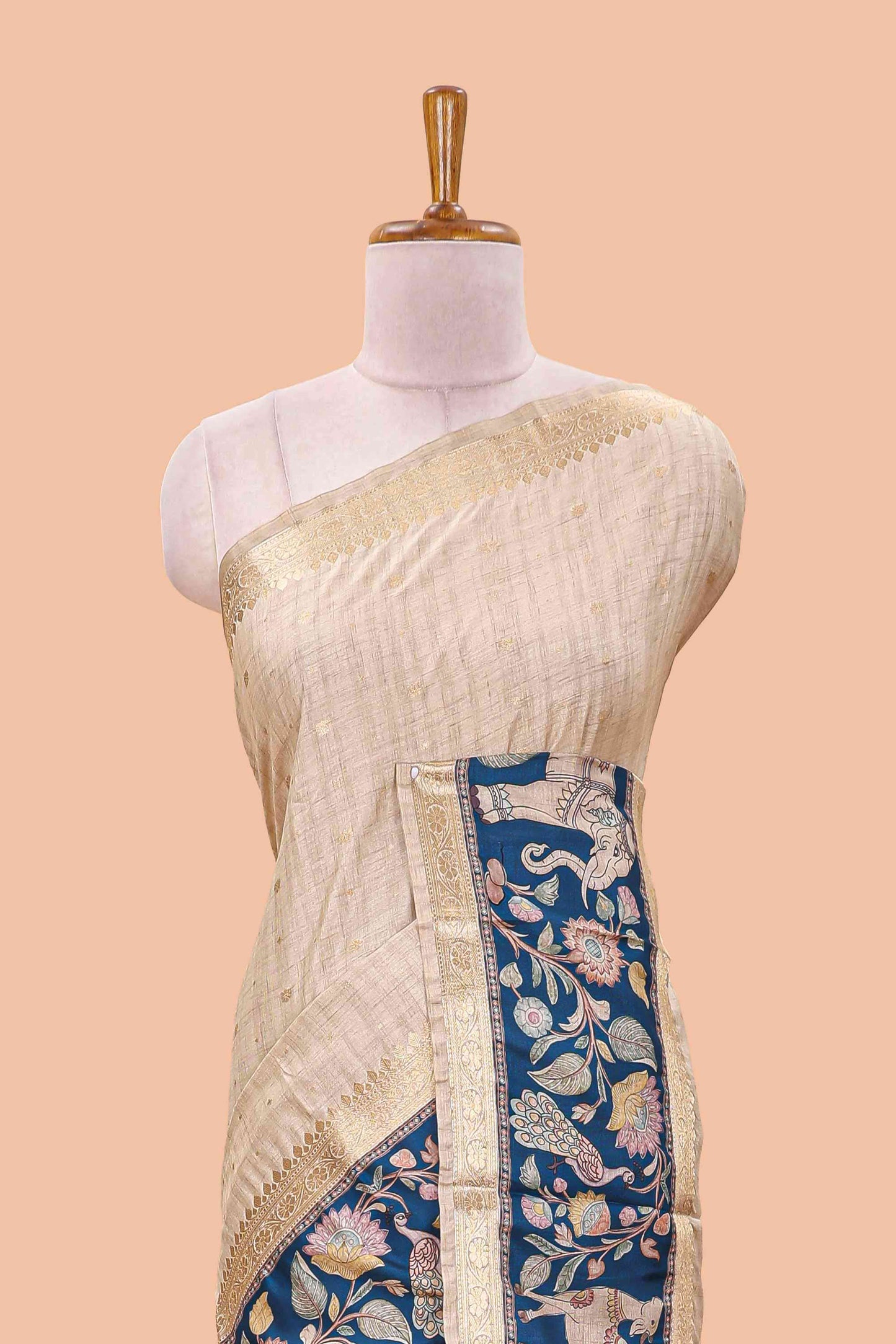 Beige art tussar silk saree featuring zari butta and blue retta-patta border with kalamkari animal designs