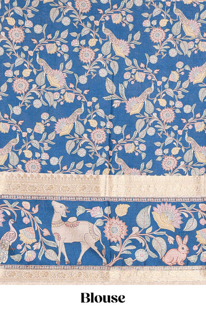 Beige art tussar silk saree featuring zari butta and blue retta-patta border with kalamkari animal designs