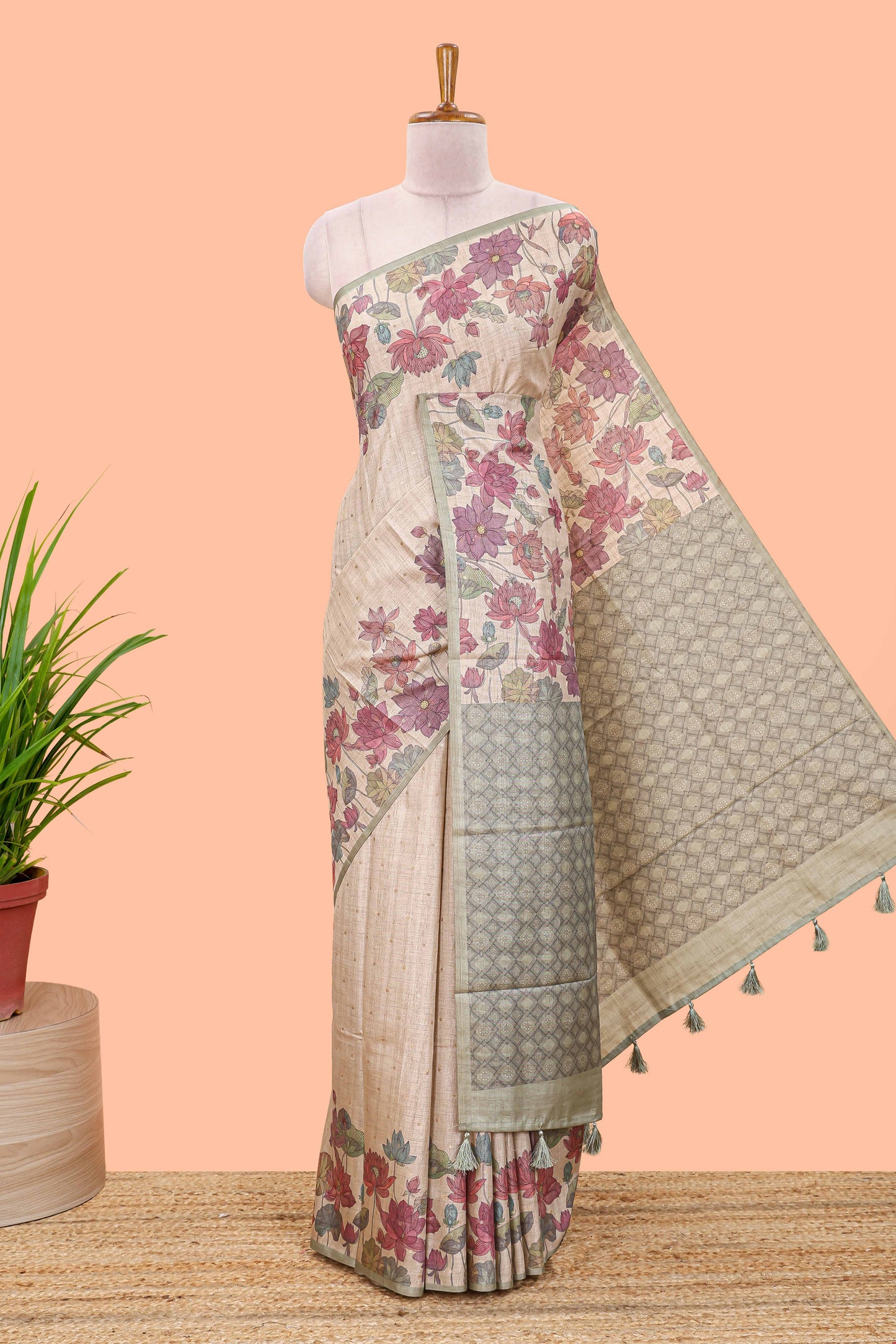 Beige art tussar silk saree with small zari butta weaving and floral print pale green border and pallu