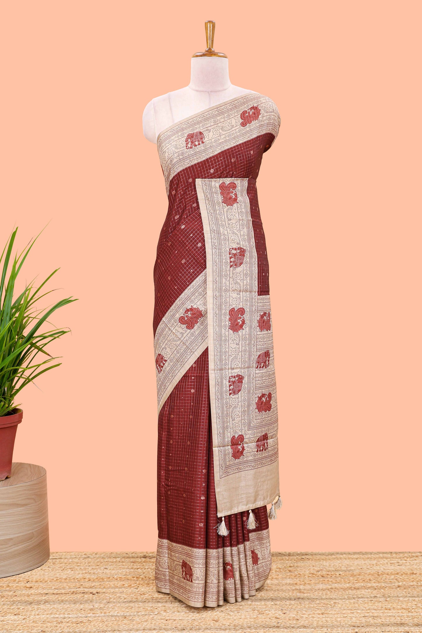 Maroon art tussar saree with zari check and butta weave, cream border and kalamkari elephant and peacock motif border and pallu