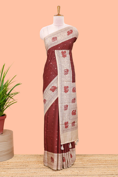 Maroon art tussar saree with zari check and butta weave, cream border and kalamkari elephant and peacock motif border and pallu