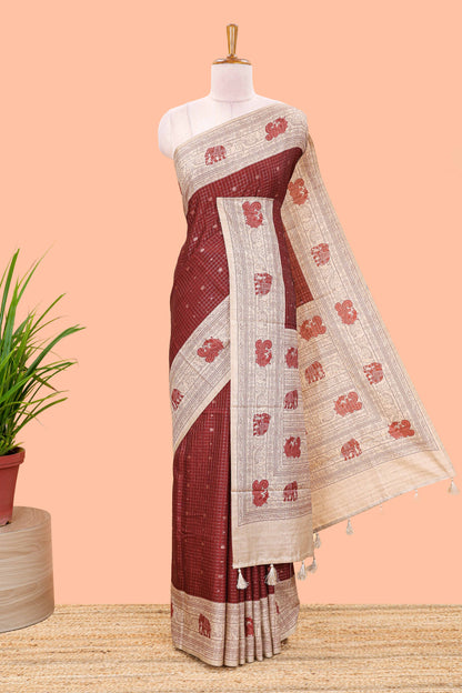 Maroon art tussar saree with zari check and butta weave, cream border and kalamkari elephant and peacock motif border and pallu