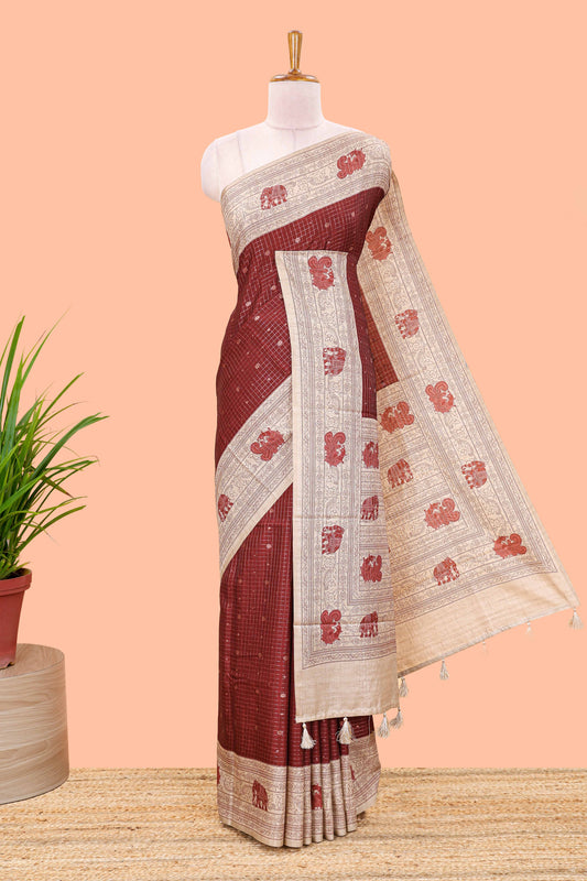 Maroon art tussar saree with zari check and butta weave, cream border and kalamkari elephant and peacock motif border and pallu