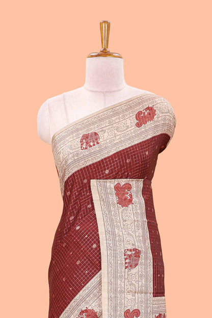 Maroon art tussar saree with zari check and butta weave, cream border and kalamkari elephant and peacock motif border and pallu