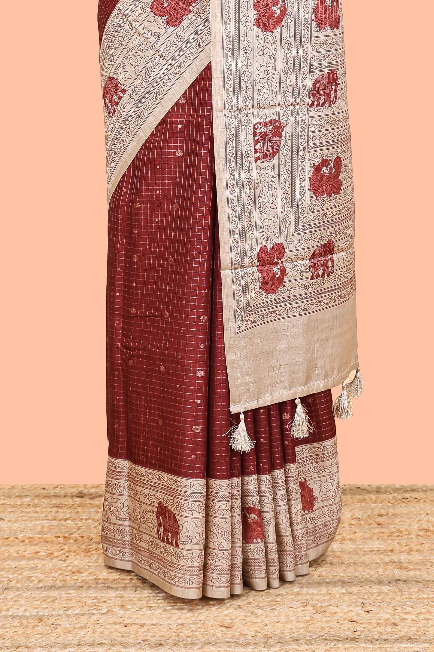 Maroon art tussar saree with zari check and butta weave, cream border and kalamkari elephant and peacock motif border and pallu
