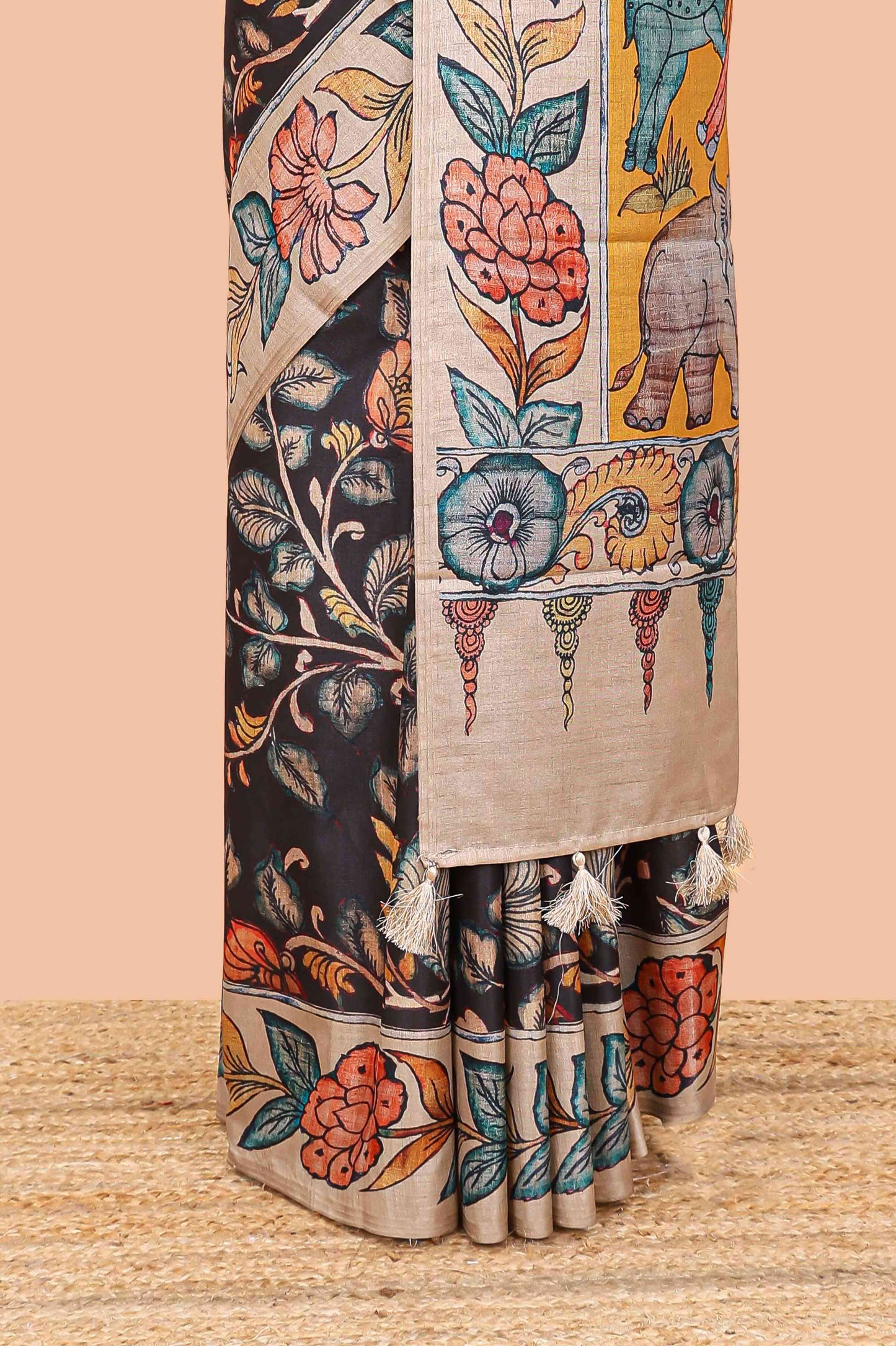 Black art tussar silk saree with leaf and floral printed body, cream border, and floral & animal print pallu