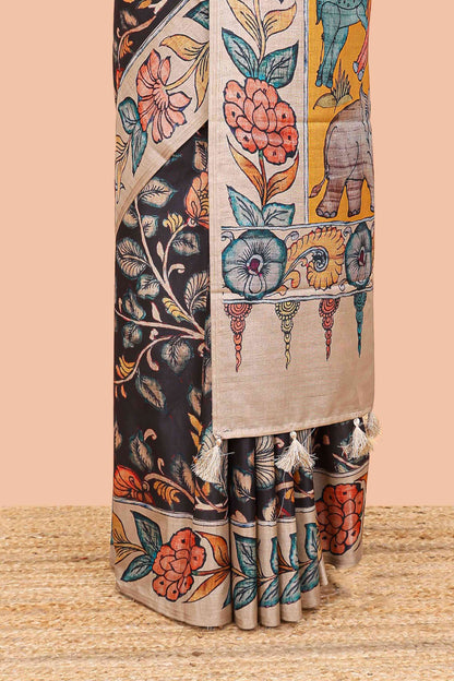 Black art tussar silk saree with leaf and floral printed body, cream border, and floral & animal print pallu