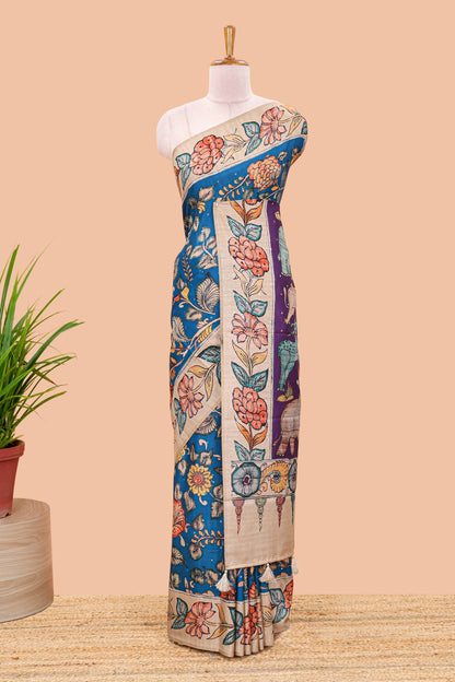 Blue art tussar silk saree with leaf and floral printed body, cream border, and floral & animal print pallu
