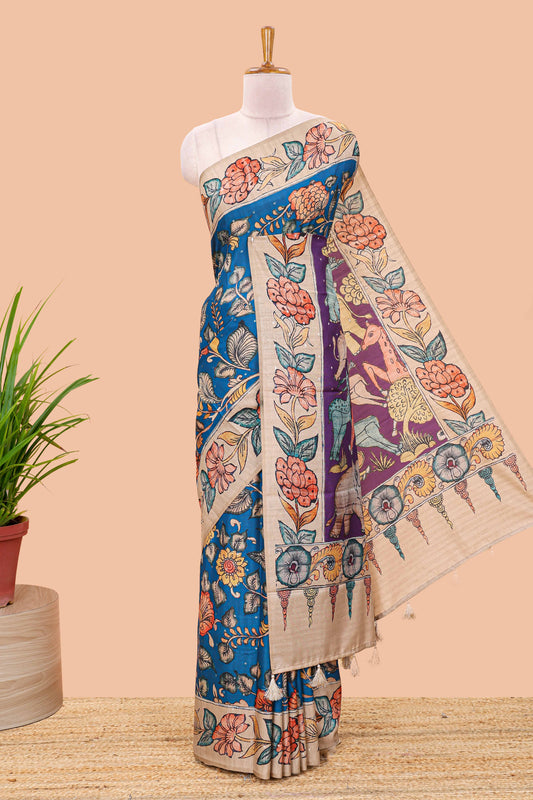 Blue art tussar silk saree with leaf and floral printed body, cream border, and floral & animal print pallu