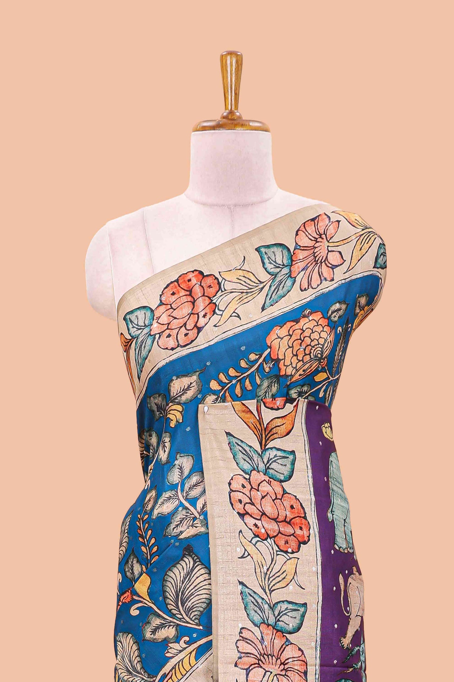 Blue art tussar silk saree with leaf and floral printed body, cream border, and floral & animal print pallu